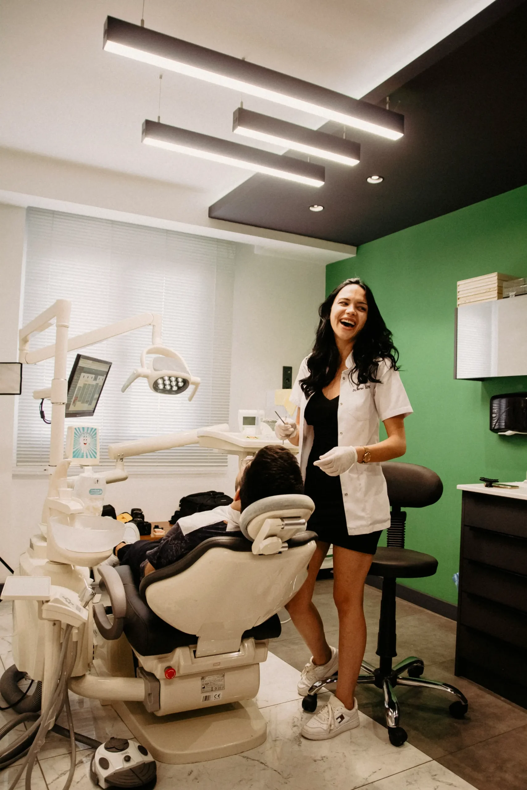 Dental surgery with a treatment chair and a green feature wall
