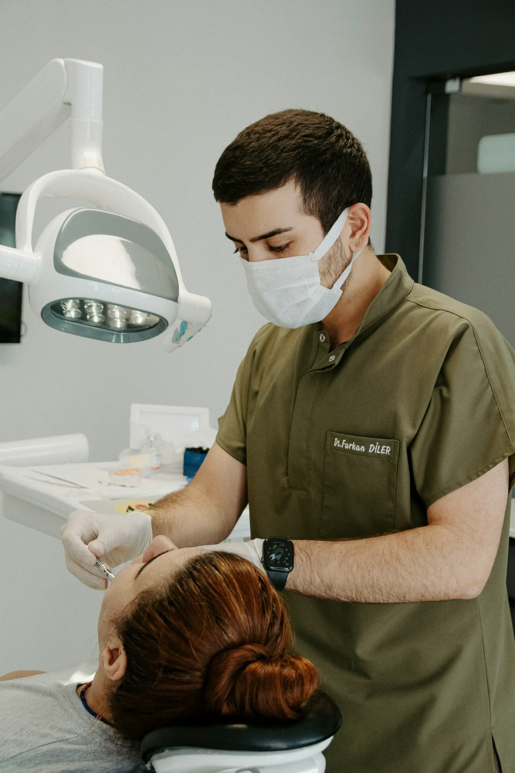 Dentist in a face mask treating a patient