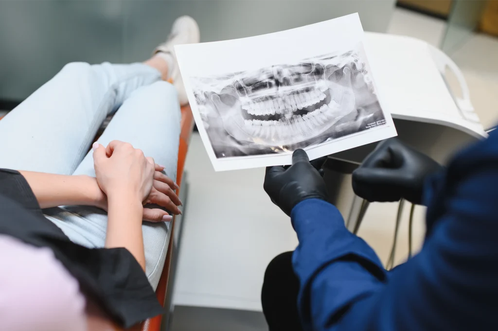 Dentist showing a patient a panoramic dental X-ray