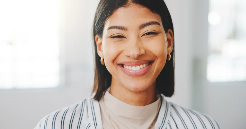 Smiling young woman in a bright office