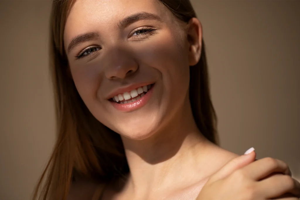Young woman smiling in warm golden-hour light