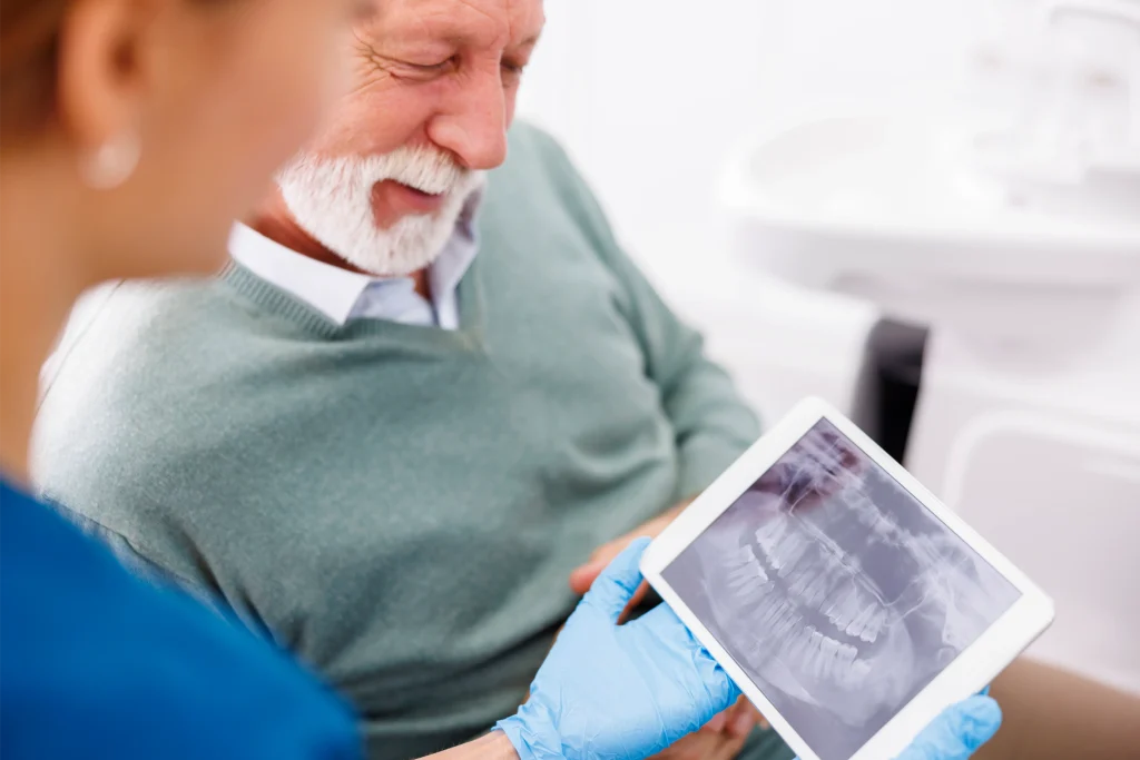 Senior man reviewing a dental X-ray with his dentist