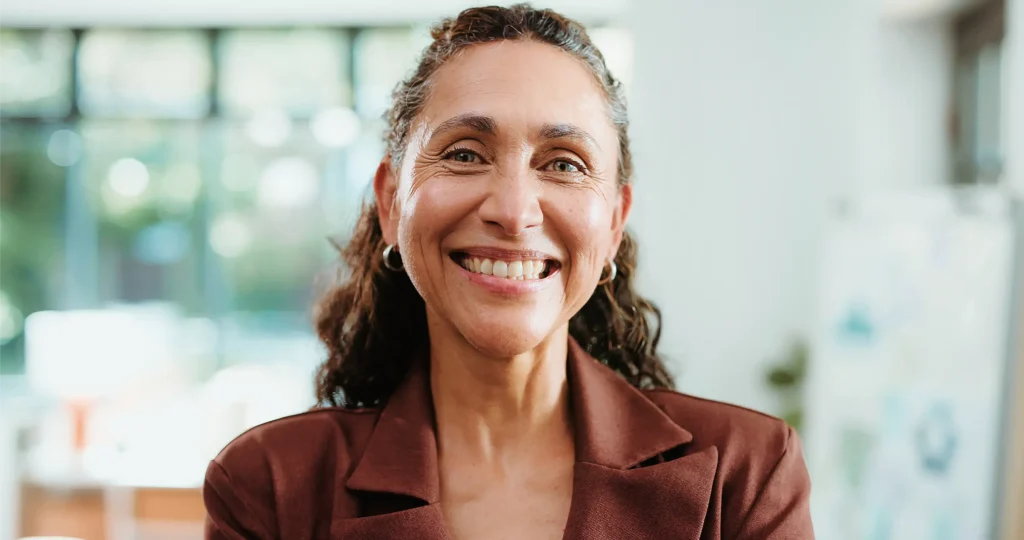 Smiling woman in a brown blazer