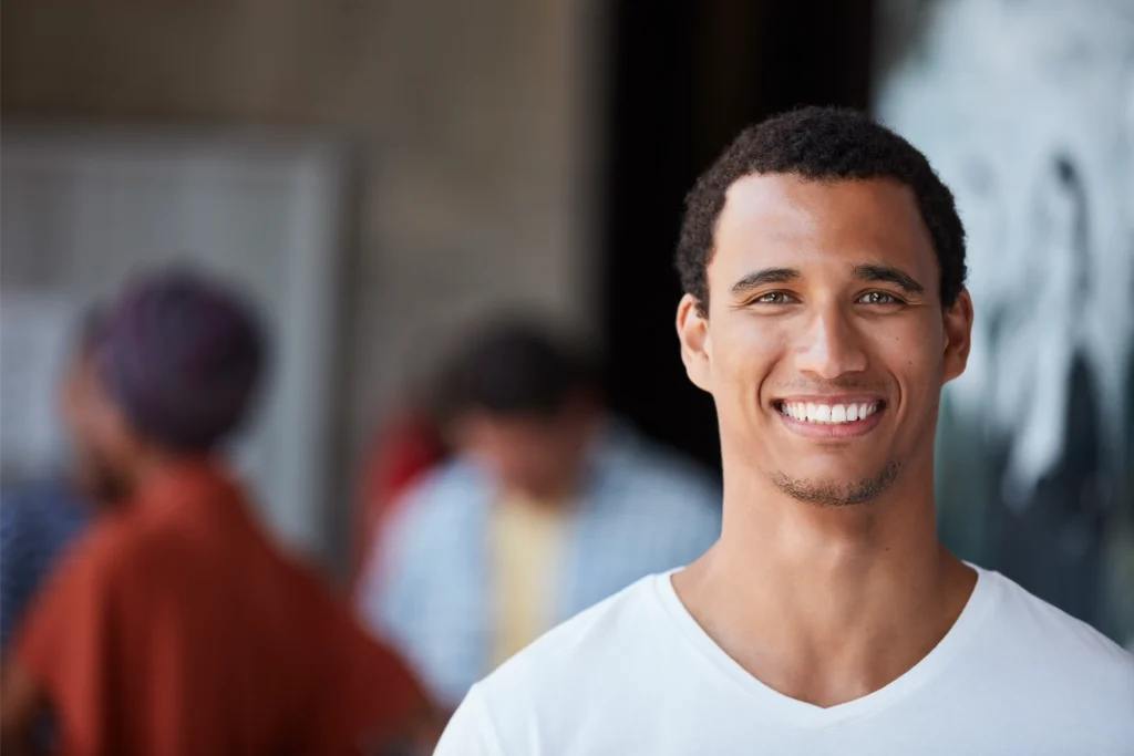 Smiling young man in a white T-shirt