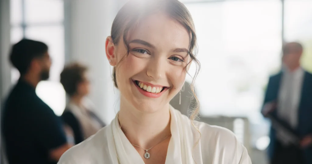 Smiling young woman in a white blouse
